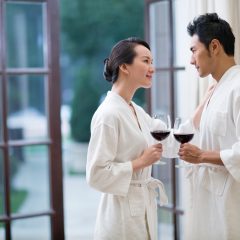 Loving couple with wine in a luxury hotel